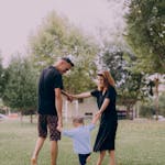 Parents Playing with Their Child in a Park